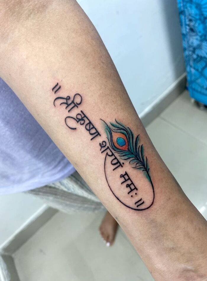 this tattoo represents lord krishna it has mantra…